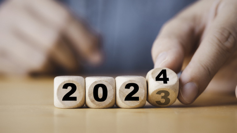 Hand flipping of 2023 to 2024 on wooden block cube for preparation new year change and start new business target strategy concept.